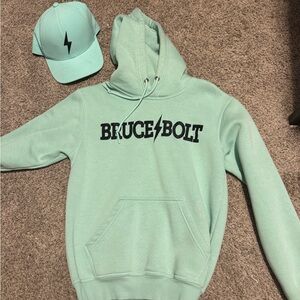 Bruce bolt youth large sweatshirt and matching hat. Neither has ever been worn.
